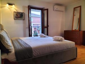 a bedroom with a bed with two towels on it at Big Bright Flat in Milano close to Loreto square in Milan