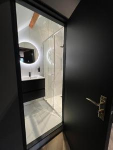 a bathroom with a glass shower and a sink at Boutique Hotel de Kade Zaandam-Amsterdam in Zaandam