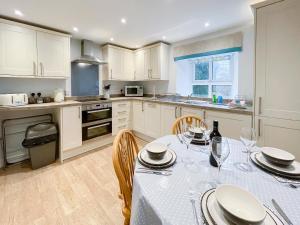 a kitchen with a table and chairs in a kitchen at Riverview Cottage in Hartington