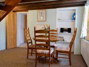 a dining room with a table and chairs at Commonwealth Cottage in Iron Acton