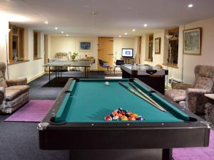 a living room with a pool table and two tables at Barn Terrace - 28972 in Selstead