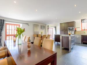 a kitchen and dining room with a table and chairs at Trescowthick Barn in Zelah