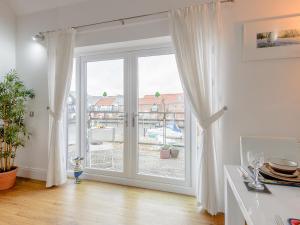a white room with a large sliding glass door at Quay Side in Lincoln