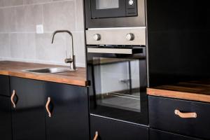 a kitchen with a stainless steel oven and a sink at Ocean Nomads Coworking in Arona