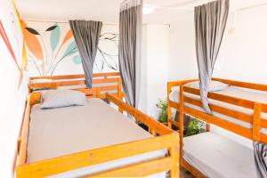 a room with two bunk beds in a house at Ocean Nomads Coworking in Arona