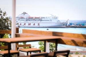 a cruise ship is docked in a harbor at Ocean Nomads Coworking in Arona