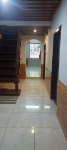 a hallway with a staircase in a building at Chitlatda Bila House in Luang Prabang
