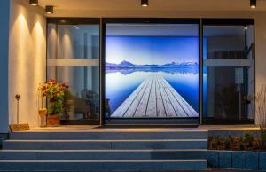 a room with a view of a lake on the wall at Hotel Filser in Füssen