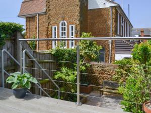 a metal railing in front of a brick building at The Mistress House in Hunstanton