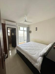 a bedroom with a large bed and a window at Villa Vista With Swimming Pool in Lucknow