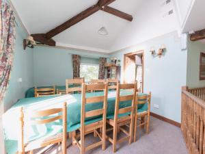 a bedroom with a bed and chairs in a room at Clusters Chapel in Belper