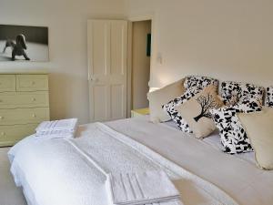a bed with pillows on it in a bedroom at Midships in Instow