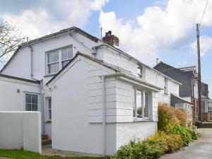 a white house with a roof at Trecarian in Port Isaac