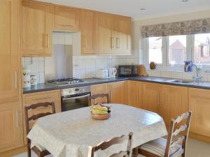 a kitchen with a table with a bowl of fruit on it at Carmichael in Longridge