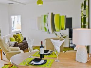 a living room with a table with a bottle of wine at Llwynbedw - 28464 in Cardigan