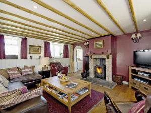 a living room with a couch and a fireplace at Limber View in Glaisdale