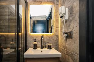 a bathroom with a sink and a mirror at Galata Master Hotel in Istanbul
