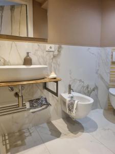 a bathroom with a sink and a toilet at Dimora Pepatio in Camporosso +8 photos