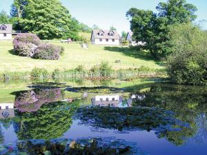 a reflection of a house in the water of a lake at Trebah - B5623 in Saint Cleer