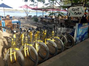 a row of bikes parked next to the beach at Ani Bungalows in Gili Trawangan