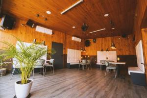 a large room with wooden ceilings and tables and chairs at CARIBBEAN Home in Montcada i Reixac