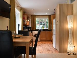 a kitchen with a wooden table and a dining room at Rose Corner in Countess Wear