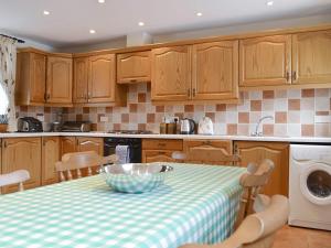 a kitchen with a table with a bowl on it at The Old Byre - 24970 in Frosterley