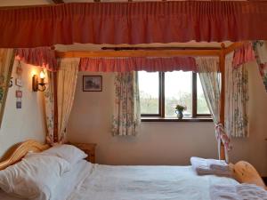 a bedroom with two beds and a window at Brandy's in Colyton