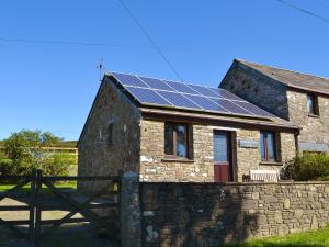 a house with solar panels on the roof at Roosters Perch in Saint Kew