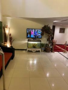 a living room with a flat screen tv on the wall at Dar Al Riyadh Apartments in Riyadh