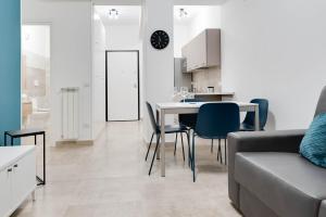 a kitchen and living room with a table and chairs at Jòia Holiday Home in Crotone