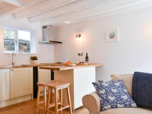 a kitchen and living room with a table and a couch at Esk Cottage in Egton