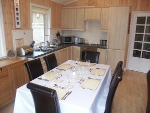 a kitchen with a table with wine glasses on it at Amber Nook in Tirril