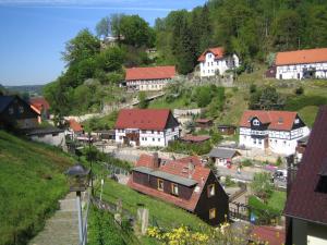a village on a hill with houses and buildings at Ferienwohnung Gisela Winkler in Rathen