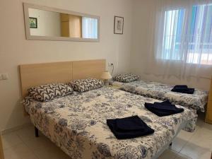 A bed or beds in a room at Apartament La Mata "FELIZ"
