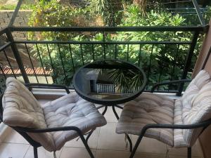 a table and chairs on a balcony with a mirror at City center home in Karataş