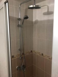 a shower with a glass door in a bathroom at City center home in Karataş