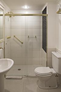 a bathroom with a shower and a toilet and a sink at Transamerica Classic Higienópolis in Sao Paulo