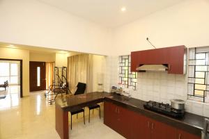 a kitchen with a counter top in a room at Nest Villa Yelagiri By Lexstays in Yelagiri