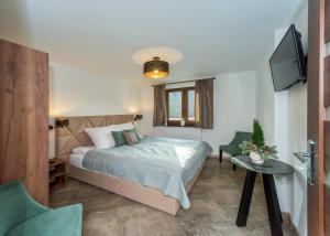 a bedroom with a bed and a flat screen tv at Willa Bukowa in Brenna