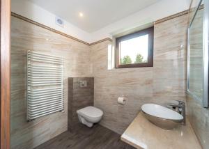 a bathroom with a sink toilet and a window at Willa Bukowa in Brenna +19 photos