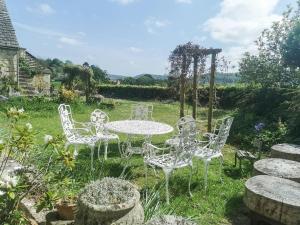 a white table and chairs in a garden at Violet Cottage in Dudbridge