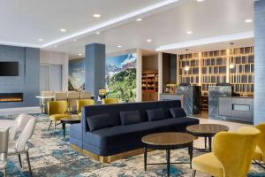 - un salon avec un canapé, des tables et des chaises dans l'établissement La Quinta Inn & Suites by Wyndham Denver Parker, à Parker