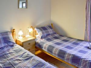 フランボローにあるRobinのベッドルーム1室(ベッド2台、ナイトスタンド、ランプ2つ付)