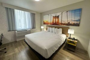 a bedroom with a large bed and a large window at Days Inn by Wyndham Brooklyn Eastern Parkway in Brooklyn