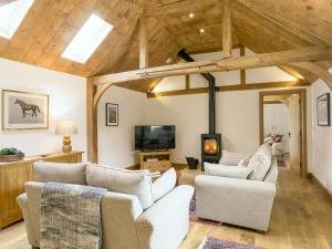 a living room with white furniture and wooden ceilings at The Calf Shed-ukc2113 in Royal Wootton Bassett