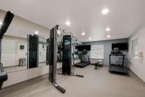 a gym with tread machines and mirrors in a room at WoodSpring Suites San Antonio UTSA - Medical Center in San Antonio