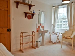 a bathroom with a sink and a toilet in a room at Daisy Bank Cottage in Bowness-on-Windermere