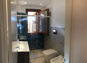 a bathroom with a toilet and a sink and a shower at Villa Smeralda in San Vito lo Capo +38 photos