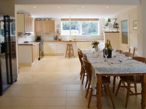 a kitchen with a table with wine glasses on it at Cobden House in Lakenheath